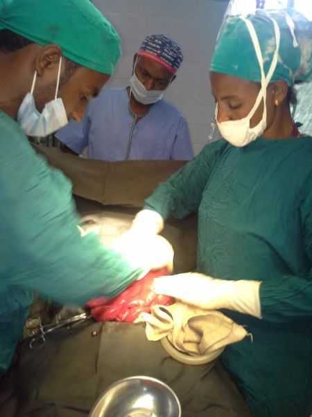 Picture of surgeon, assistant and anaesthetist during a trauma laparotomy